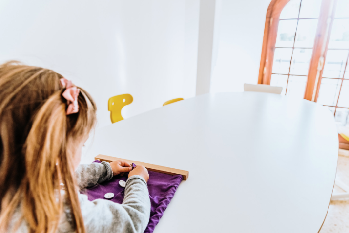 enfant qui joue avec du materiel montessori